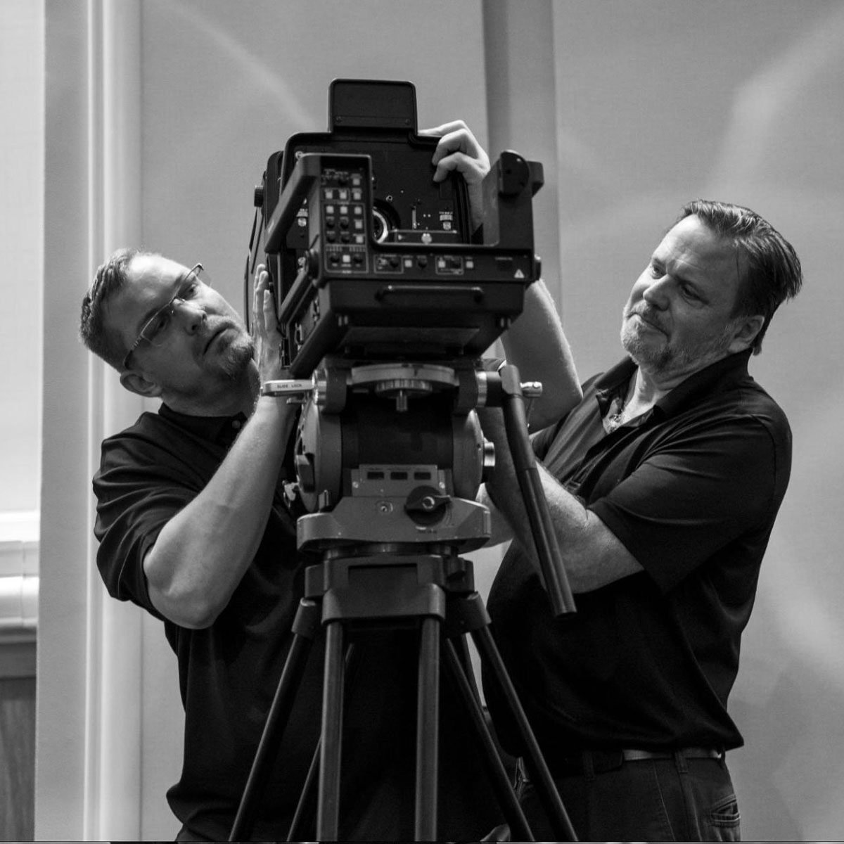 Two AV techs working on a camera. 